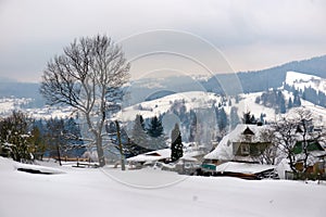 Typical landscape of the Ukrainian Carpathians with private estates in winter