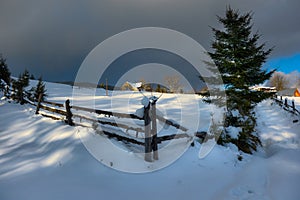 Typical landscape of the Ukrainian Carpathians with private estates in winter