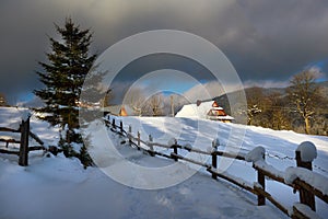 Typical landscape of the Ukrainian Carpathians with private estates in winter