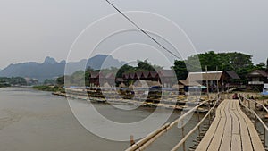 Typical Laos nature and wooden bridge.