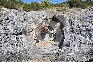 The typical limestone cavernous cliffs along the Cilento coast, Italy. Coastal area.