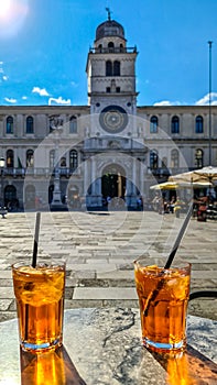 A typical local aperetivo in Padua in Veneto, Italy. Aperol Spritz. Bar near stronomical clock tower on Piazza dei Signori, Padua