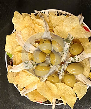 Typical Madrilenian tapa, olives with boquerones en vinagre and french fries, photo