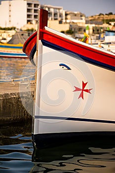 typical Maltese boat, called luzzo, with the traditional eyes and Maltese cross drawn on the bow