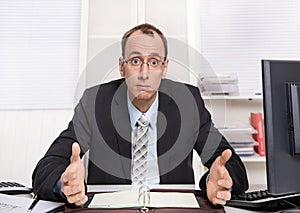 Typical managing director or controller - arrogant and disagreeable sitting at desk with computer