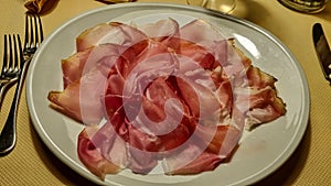 Sauris - Typical meat plate served in traditional mountain restaurant in Carnic Alps, Friuli Venezia Giulia