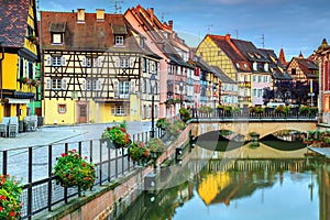 Typical medieval half-timbered facades reflecting in water,Colmar,France
