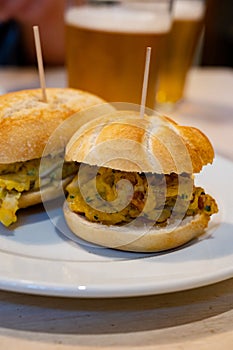 Typical mini burger snack of Basque Country, pinchos or pinxtos, small piece of bread with different toppings, served in bar in