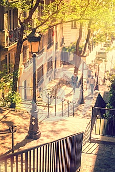 Typical Montmartre staircase and old street lamp, golden sunny light in Paris France