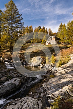 Typical mountain hut on the river in the Alps on the Simplonpass