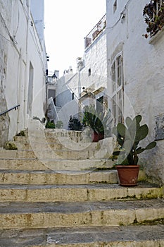Typical narrow little street with a lots of stairs in Ostuni, La Citta Bianca. Ostuni. Puglia, Italy