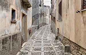 Typical narrow stone street in the medieval historical center of Erice, province of Trapani in Sicily.