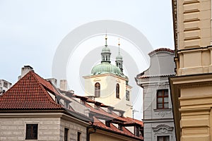 Typical narrow street of Stare Mesto in the historical center of Prague, Czech Republic, with a focus on top of the clock tower