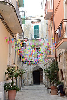 Typical narrow street with white walls in South Italy