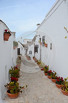 Typical narrow street with white walls in South Italy