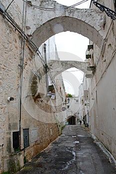 Typical narrow street with white walls in South Italy