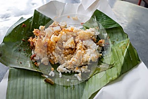 A typical nasi lemak or fragrant rice cooked in coconut milk and pandan leaf, peppered with anchovies, cucumber and omelette . It