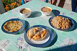 Typical nepalese meal on Manaslu Circuit, Himalayas, Nepal. Assorted indian nepalese food on table. Dishes and appetizers