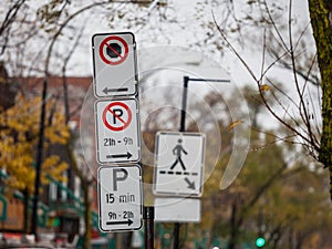 Typical North American paking and no parking signs with detailed instructions on the parking regulations taken in Montreal, Quebec photo