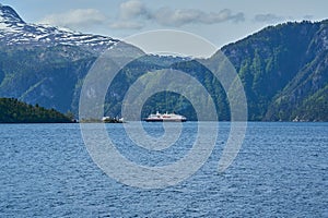 typical norwegian car ferry crossing a beautiful fjord