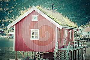 Typical Norwegian fishing village with traditional red rorbu hut