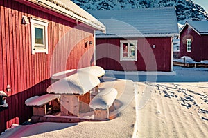 Typical Norwegian wooden red houses in Ballstad town, located on the shore of Norwegian sea.