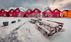 Typical Norwegian wooden red houses in Ballstad town, located on the shore of Norwegian sea.