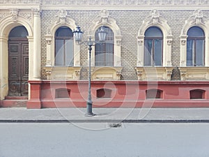 Typical Novi Sad old town street view in Serbia with old doors and windows and vintage candelabre