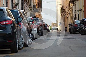 Typical old city street. Cars parked along the street.