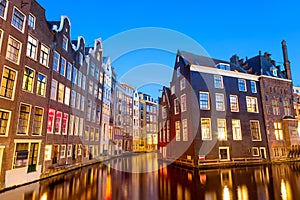 Typical old dutch houses over canal with reflections at twilight in Amsterdam, North Hilland, Netherlands. Amsterdam postcard.