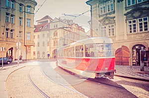 Typical old retro vintage tram on tracks near tram stop in the streets of Prague city