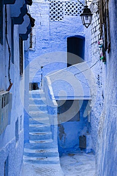 Old narrow blue painted street in the medina of Chefchaouen, Morocco