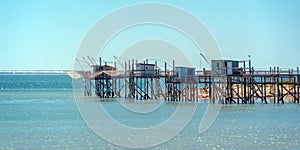 Typical old wood fishing huts on stilts in the atlantic ocean near La Rochelle, France