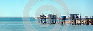 Typical old wooden fishing huts on stilts in the atlantic ocean near La Rochelle France