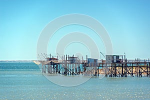 Typical old wooden fishing huts on stilts in the atlantic ocean near La Rochelle France