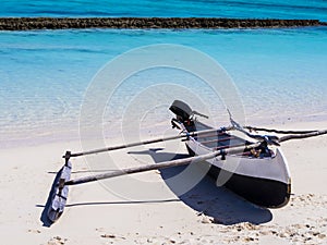 Typical outrigger pirogue moored on turquoise reef of Nosy Ve island, Indian Ocean, Madagascar