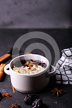 Typical Peruvian dessert: rice pudding and purple mazamorra on a dark background.