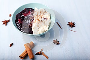 Typical Peruvian dessert: rice pudding and purple mazamorra on a light blue background.