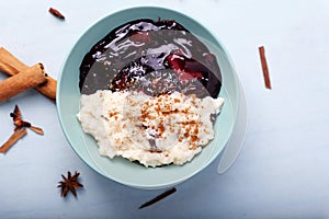 Typical Peruvian dessert: rice pudding and purple mazamorra on a light blue background.