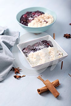 Typical Peruvian dessert: rice pudding and purple mazamorra on a light blue background.