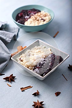 Typical Peruvian dessert: rice pudding and purple mazamorra on a light blue background.