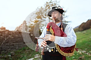Typical player in traditional bergamo bagpipe from the alpine valleys of northern Italy