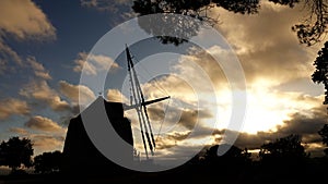 Typical Portugese windmill in Pedreias in Portugal at sunset photo