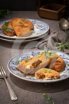Typical Portuguese appetizer rissois or rissoles, meat or shrimp breaded turnovers. Parsley on the background