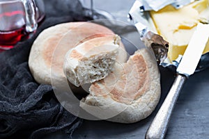 Typical portuguese bread Bolo do Caco with butter and knife