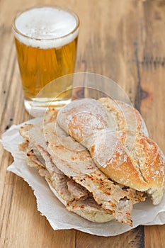 Typical portuguese dish bifanas vendas novas with glass of beer on white plate photo