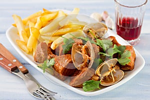 Typical portuguese dish Carne de Porco a Alentejana photo