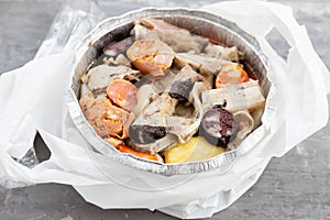 Typical portuguese dish cozido a portuguesa in plastic box take away photo