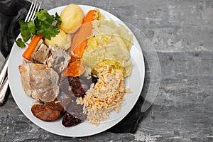 Typical portuguese dish cozido a portuguesa on white dish photo