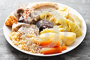 Typical portuguese dish cozido a portuguesa on white dish photo